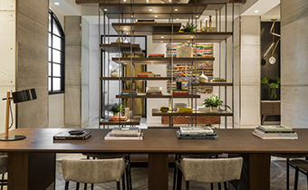 hotel lobby with shelves tables and chairs